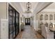 The hallway features custom lighting, wood floors, custom trim, and barn doors at 22406 N 36Th Way, Phoenix, AZ 85050