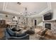 Open-concept living room featuring a fireplace and seamless flow to kitchen at 22406 N 36Th Way, Phoenix, AZ 85050