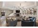 Elegant living room featuring a fireplace, custom built-ins, and abundant seating at 22406 N 36Th Way, Phoenix, AZ 85050