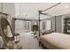 Relaxing main bedroom featuring a seating area, canopy bed, and decorative accents at 22406 N 36Th Way, Phoenix, AZ 85050