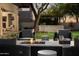 Backyard patio with outdoor seating, fire pit, bar area and manicured landscaping at 22406 N 36Th Way, Phoenix, AZ 85050