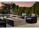 Outdoor patio with fire pit, cushioned seating, and a pool surrounded by lush landscaping at 22406 N 36Th Way, Phoenix, AZ 85050