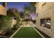 A private putting green and outdoor kitchen offer relaxation and recreation in the backyard at 22406 N 36Th Way, Phoenix, AZ 85050