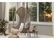 Cozy sitting area with hanging chair, plush cushions, and natural light from the window at 22406 N 36Th Way, Phoenix, AZ 85050