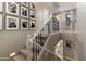 Elegant staircase with carpeted steps, decorative railing, and Gathering photo gallery at 22406 N 36Th Way, Phoenix, AZ 85050