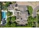 Expansive aerial view showcases a luxury home with solar panels, pool, outdoor seating, and lush landscaping at 23902 S 202Nd Ct, Queen Creek, AZ 85142