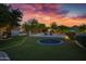 Lush backyard featuring manicured landscaping, a trampoline, and a covered outdoor kitchen at 23902 S 202Nd Ct, Queen Creek, AZ 85142