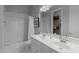 Bright bathroom with a double vanity, subway tile backsplash, and shower-tub combo at 23902 S 202Nd Ct, Queen Creek, AZ 85142