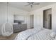 Bright primary bedroom featuring a decorative hanging chair and stylish gray dresser at 23902 S 202Nd Ct, Queen Creek, AZ 85142
