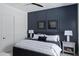 Bedroom with dark accent wall, ceiling fan, a queen bed, and bedside tables at 23902 S 202Nd Ct, Queen Creek, AZ 85142