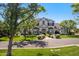 Lovely home framed by trees showcasing mature landscaping and a manicured lawn at 23902 S 202Nd Ct, Queen Creek, AZ 85142