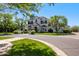 Beautiful home with a circular driveway, meticulously landscaped front yard, and mature trees at 23902 S 202Nd Ct, Queen Creek, AZ 85142