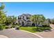 Stately home featuring lush landscaping, mature trees, and a circular driveway at 23902 S 202Nd Ct, Queen Creek, AZ 85142