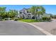 Attractive two-story home with circular drive and mature trees, complemented by a lush green lawn and well-maintained shrubbery at 23902 S 202Nd Ct, Queen Creek, AZ 85142