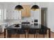 Stylish kitchen island with a black countertop and modern pendant lighting at 23902 S 202Nd Ct, Queen Creek, AZ 85142