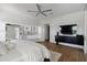 Spacious main bedroom featuring a ceiling fan, artwork, and hardwood flooring at 23902 S 202Nd Ct, Queen Creek, AZ 85142