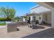 Elegant outdoor kitchen with built-in barbecue grill and dining area under a large umbrella at 23902 S 202Nd Ct, Queen Creek, AZ 85142