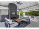 Cozy outdoor living space with a fireplace, comfortable seating, and a barbecue grill at 23902 S 202Nd Ct, Queen Creek, AZ 85142