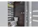 Modern outdoor shower featuring dark tile and gray privacy screens, perfect for poolside rinsing at 23902 S 202Nd Ct, Queen Creek, AZ 85142