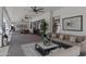 Comfortable outdoor patio with ceiling fans, brick flooring, and modern furniture at 23902 S 202Nd Ct, Queen Creek, AZ 85142
