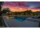 Sparkling pool area with a covered outdoor kitchen, lounge chairs and inviting sunset views at 23902 S 202Nd Ct, Queen Creek, AZ 85142