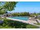 Refreshing pool with waterfall feature and lounge chairs surrounded by lush greenery at 23902 S 202Nd Ct, Queen Creek, AZ 85142