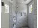 Elegant marble shower with dual shower heads and convenient inset shelving at 23902 S 202Nd Ct, Queen Creek, AZ 85142