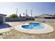 A backyard with a unique blue swimming pool and concrete patio at 2902 W Bloomfield Rd, Phoenix, AZ 85029