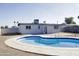 A backyard with a unique blue swimming pool and concrete patio at 2902 W Bloomfield Rd, Phoenix, AZ 85029