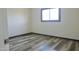This bedroom features wood flooring and a large window offering plenty of natural light at 2902 W Bloomfield Rd, Phoenix, AZ 85029