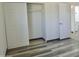 This bedroom features wood flooring, a closet with sliding doors, and an entrance to the bathroom at 2902 W Bloomfield Rd, Phoenix, AZ 85029