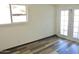 Empty bedroom with wood-look flooring and natural light from the sliding glass doors at 2902 W Bloomfield Rd, Phoenix, AZ 85029