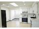 Bright kitchen with white cabinets, stainless steel appliances, and modern backsplash at 2902 W Bloomfield Rd, Phoenix, AZ 85029