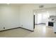 Open living room with tiled floors, and access to the kitchen with stainless steel appliances at 2902 W Bloomfield Rd, Phoenix, AZ 85029