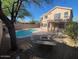 Backyard featuring a swimming pool and an outdoor fireplace at 31203 N 43Rd St, Cave Creek, AZ 85331
