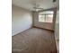 Neutral bedroom featuring carpet, ceiling fan, and a large window at 31203 N 43Rd St, Cave Creek, AZ 85331