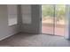 Inviting bedroom featuring neutral tones, carpet flooring, and a sliding door leading to a private balcony at 31203 N 43Rd St, Cave Creek, AZ 85331