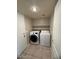 Laundry room features tile flooring, washer, dryer, and shelving at 31203 N 43Rd St, Cave Creek, AZ 85331