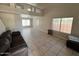 Bright living room with large windows, tile floors, and a high ceiling at 31203 N 43Rd St, Cave Creek, AZ 85331
