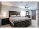 Spacious main bedroom featuring a large bed, modern ceiling fan, and barn-style closet door at 3336 E Earll Dr, Phoenix, AZ 85018