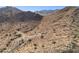 Expansive aerial view of vacant land, featuring a paved road and desert landscape at 3367 N Highlands Dr # 39, Buckeye, AZ 85396