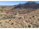 Aerial view shows a desert lot with a paved access road, presenting a unique opportunity to build your dream home at 3367 N Highlands Dr # 39, Buckeye, AZ 85396