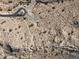 An aerial view showcasing the desert landscape and paved roads that lead to a cul-de-sac at 3367 N Highlands Dr # 39, Buckeye, AZ 85396