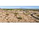 Desert landscape overlooking city and mountain views with a view of the neighborhood below at 3367 N Highlands Dr # 39, Buckeye, AZ 85396