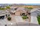 Aerial view of property showcasing a well-manicured lawn, driveway, and inviting facade at 36064 N Murray Grey Dr, San Tan Valley, AZ 85143