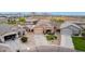 Aerial view of property showcasing a well-manicured lawn, driveway, and inviting facade at 36064 N Murray Grey Dr, San Tan Valley, AZ 85143