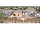 Aerial view of the backyard featuring a patio, fire pit, and block wall fence, providing a private outdoor space at 36064 N Murray Grey Dr, San Tan Valley, AZ 85143