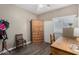 Bedroom with a wooden wardrobe and desk next to a window at 36064 N Murray Grey Dr, San Tan Valley, AZ 85143