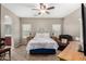 Comfortable bedroom featuring a queen-sized bed and a relaxing armchair at 36064 N Murray Grey Dr, San Tan Valley, AZ 85143