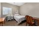 Bedroom with two desks and a bed with a floral patterned comforter at 36064 N Murray Grey Dr, San Tan Valley, AZ 85143